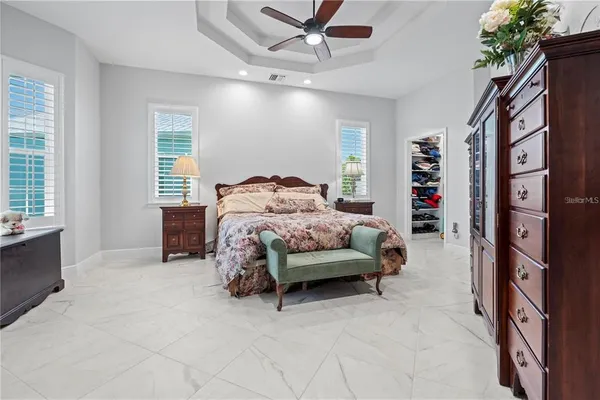 a bathroom with a granite countertop sink mirror and bathtub
