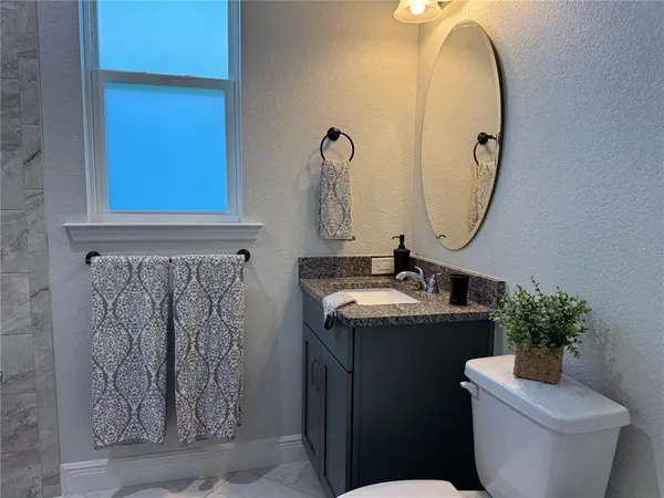 a view of a livingroom with furniture and a flat screen tv