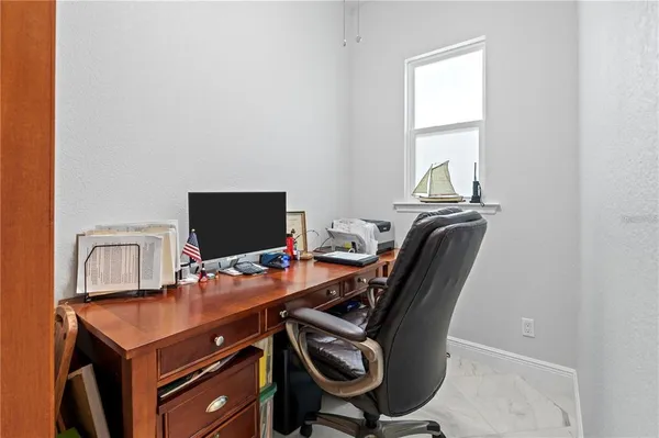 a view of a porch with chairs and backyard