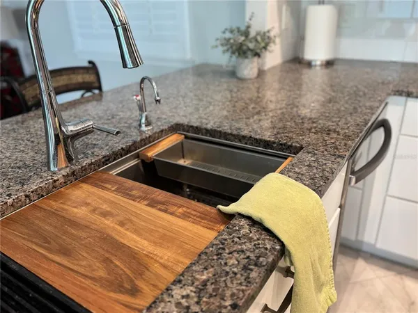 a kitchen with stainless steel appliances a refrigerator sink and cabinets