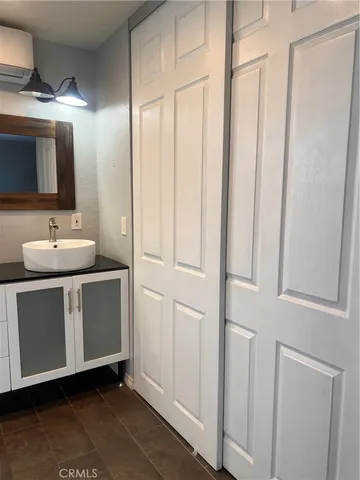 a room with a mirror and a sink