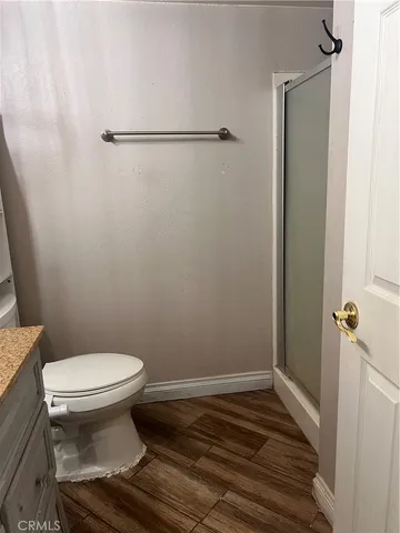 a bathroom with a toilet and a shower