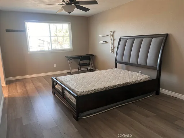 a bed sitting in a bedroom next to a window