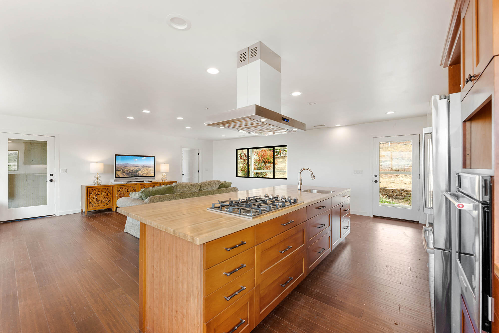 2170 Aliso Park Road New Cuyama, CA 93254 - Photo 5 of 71 a kitchen with a stove a sink a refrigerator and a dining table with wooden floor