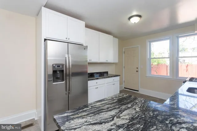 a kitchen with a refrigerator and a sink