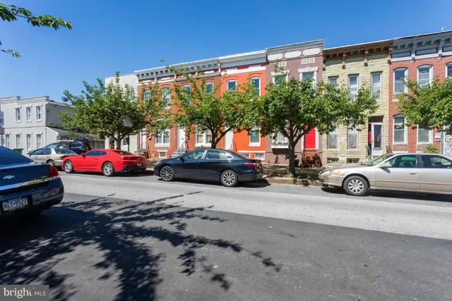 a view of car parked in front of a building