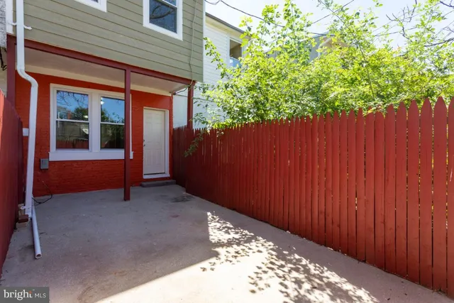 a view of a backyard with wooden fence