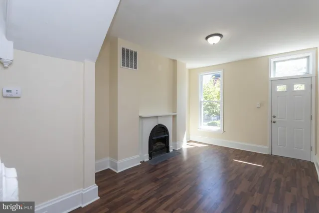 a view of a livingroom with wooden floor and a ceiling fan