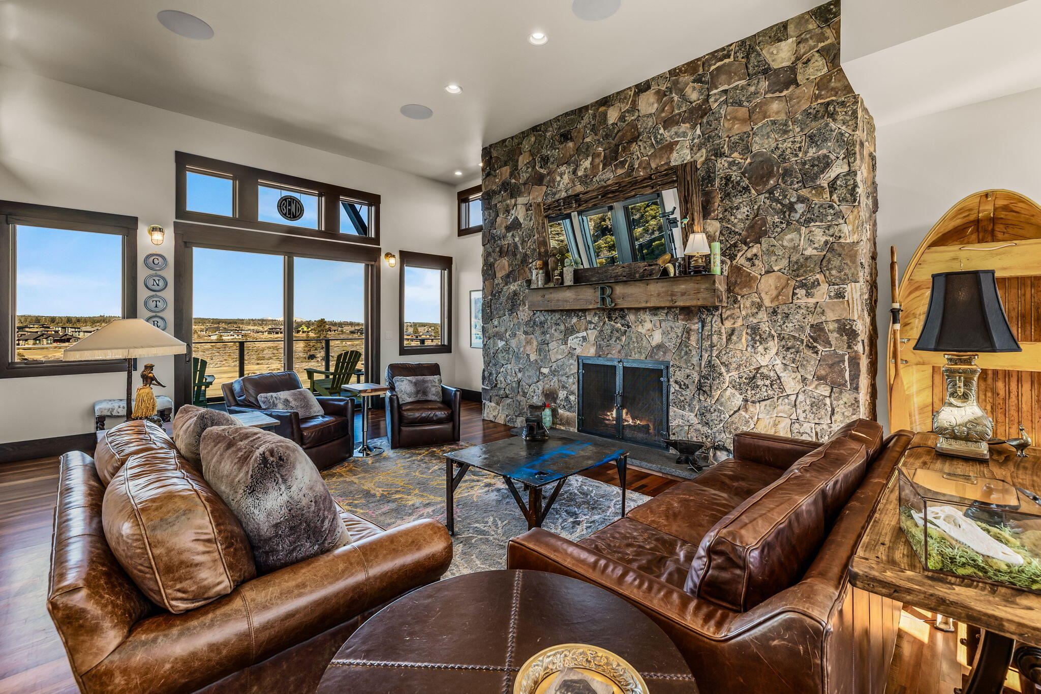 19397 Alianna Loop Bend, OR 97702 - Photo 8 of 65 Floor to ceiling Montana Mossy Rock masonry surrounds the fireplaces in the great room, primary suite and lower-level family room adding to the cozy mountain ambiance.