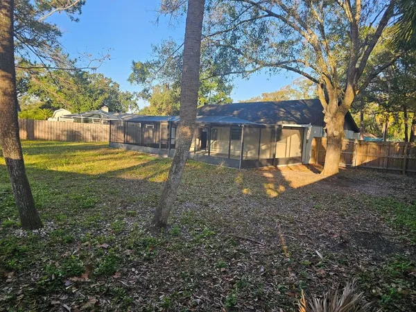 a view of a house with backyard view and sitting area