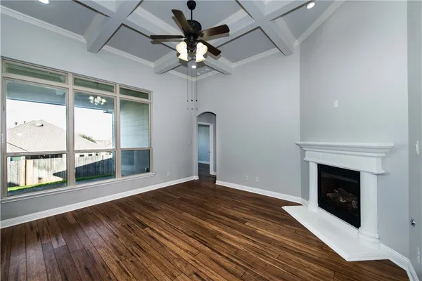 a view of a livingroom with a fireplace and wooden floor