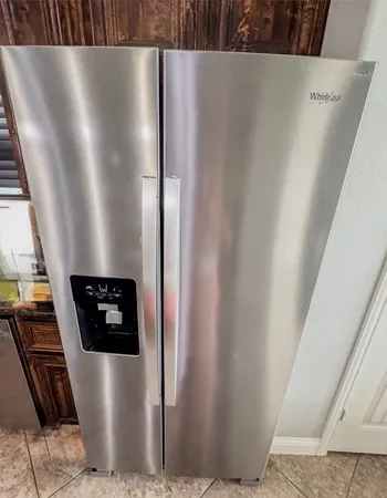 a kitchen with stainless steel appliances wooden cabinets a stove a sink and a microwave