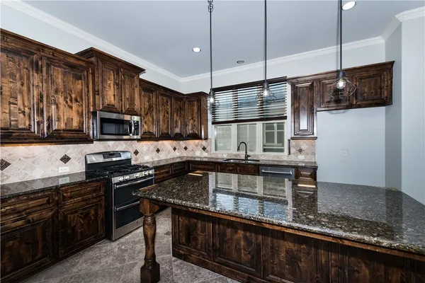 a stove top oven sitting inside of a kitchen