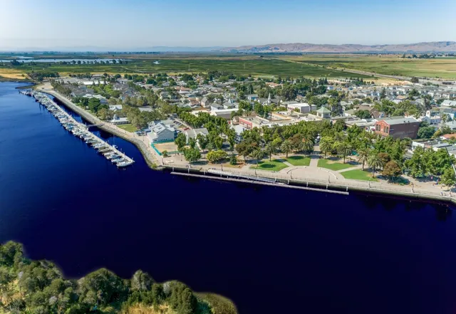 an aerial view of a house yard swimming pool and outdoor seating