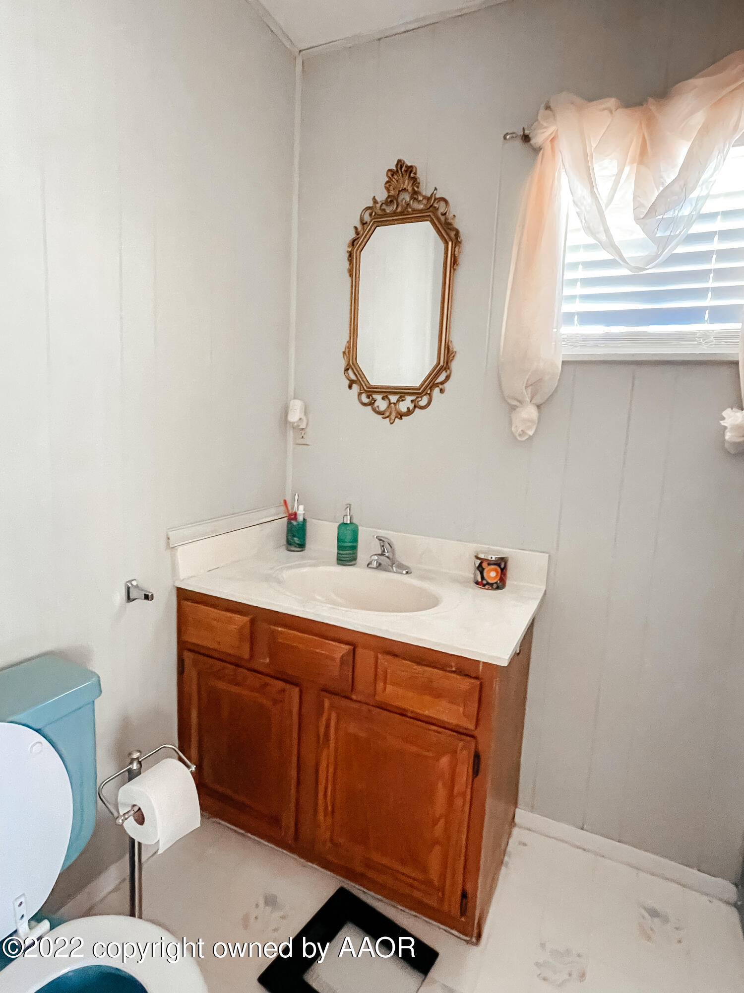 1314 Coble Drive Borger, TX 79007 - Photo 13 of 16 a bathroom with a toilet mirror vanity and a sink