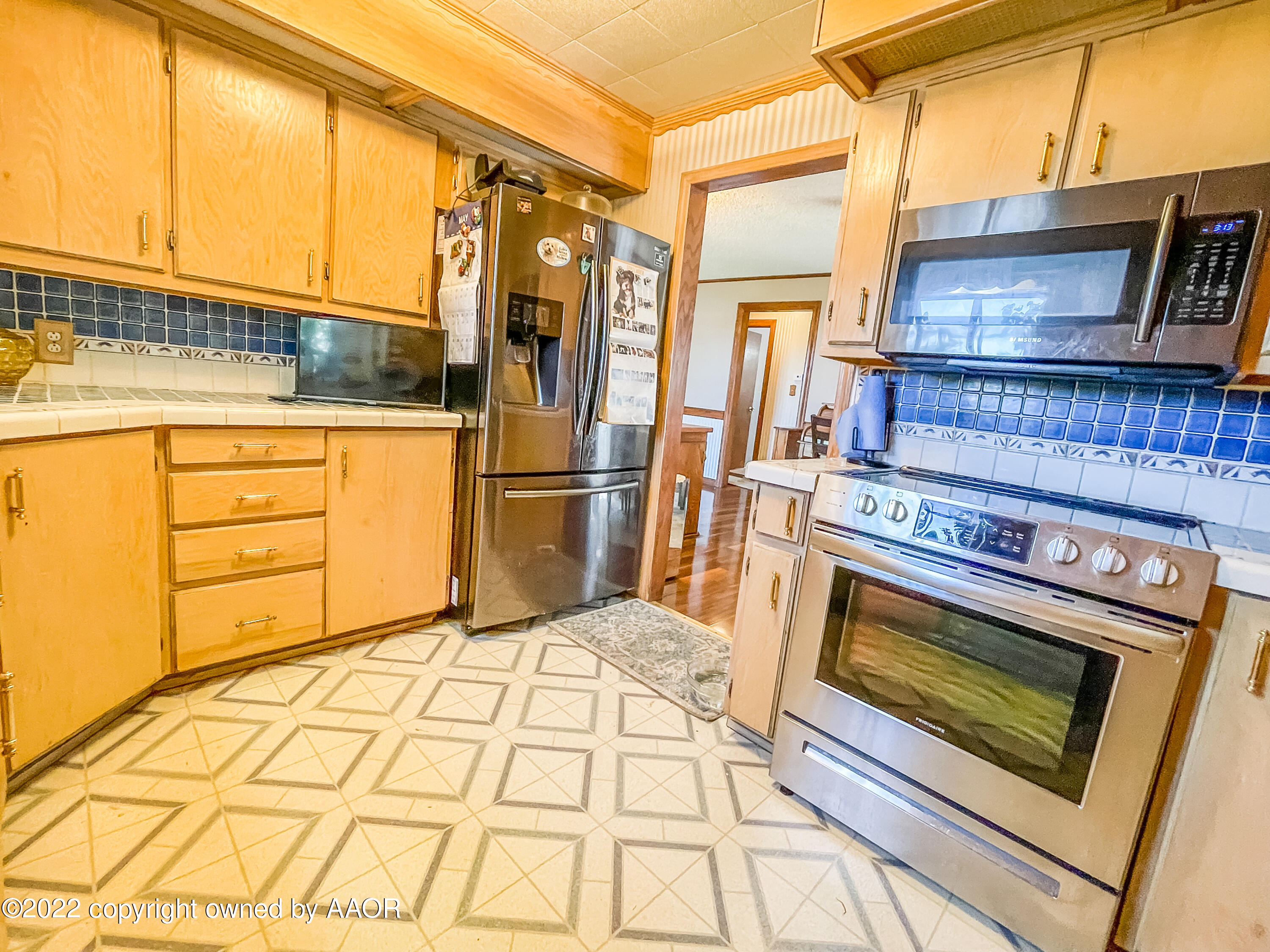 1314 Coble Drive Borger, TX 79007 - Photo 8 of 16 a kitchen with stainless steel appliances granite countertop a stove a refrigerator and a cabinets