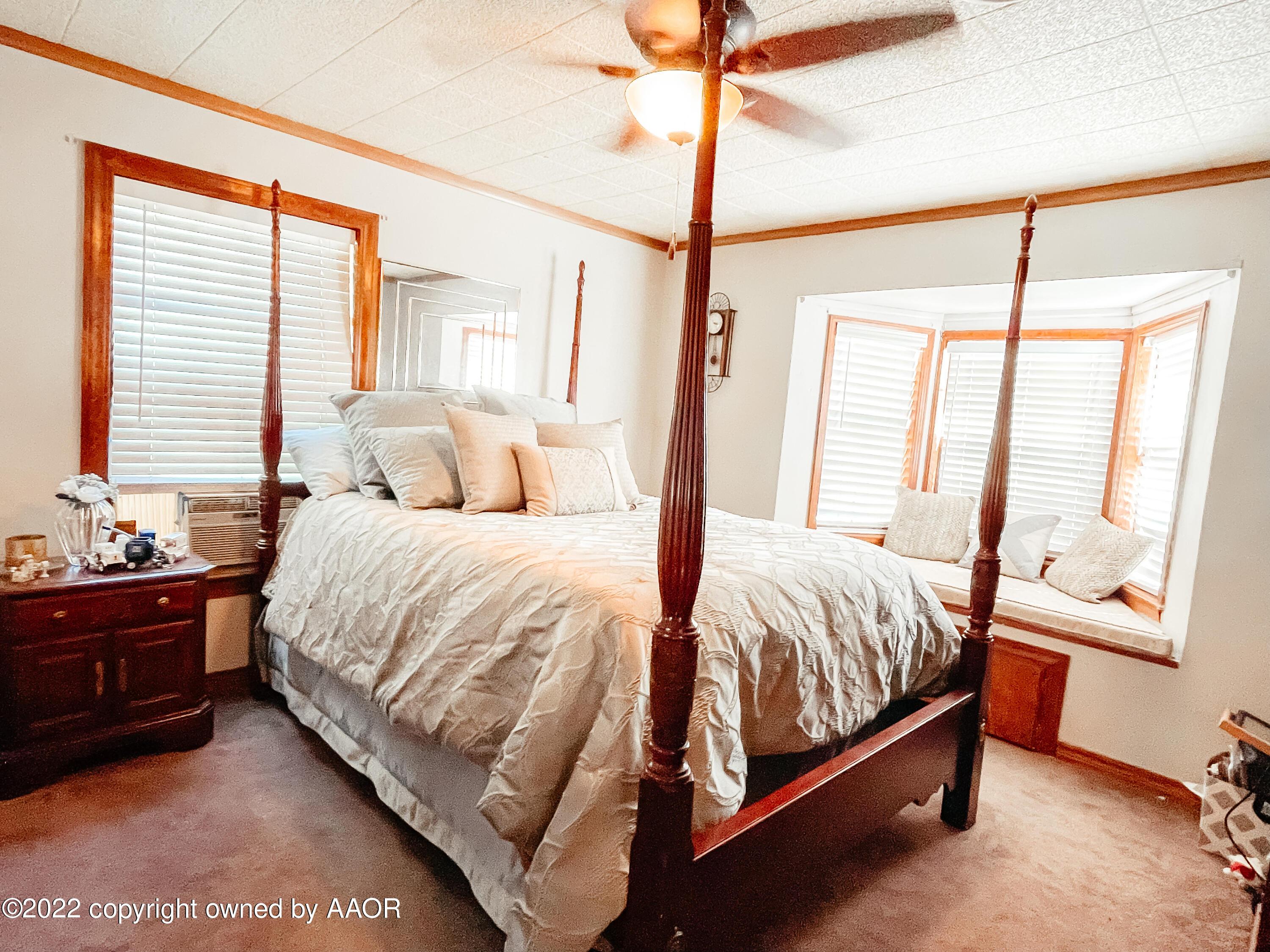 1314 Coble Drive Borger, TX 79007 - Photo 9 of 16 a bedroom with a bed lamp and a window