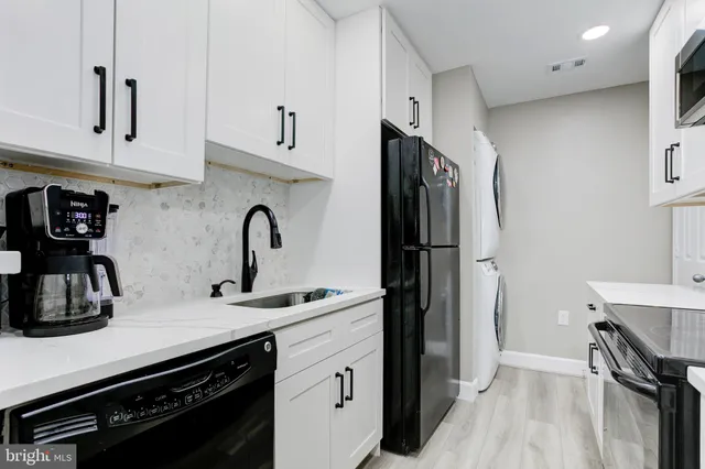 a kitchen with stainless steel appliances a sink stove and refrigerator