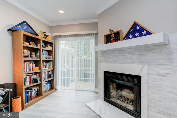 a living room with lots of books and a fireplace
