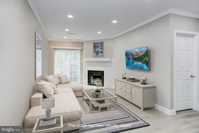 a living room with furniture a rug and a fireplace