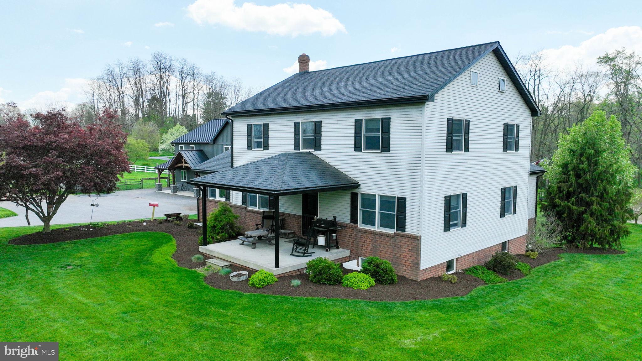 480 Jacobs Road Narvon, PA 17555 - Photo 7 of 90 a front view of a house with a yard table and chairs