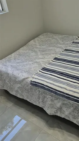 a view of a bed in a room