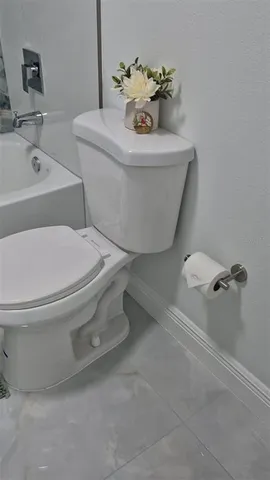 a bathroom with a sink and mirror with toilet