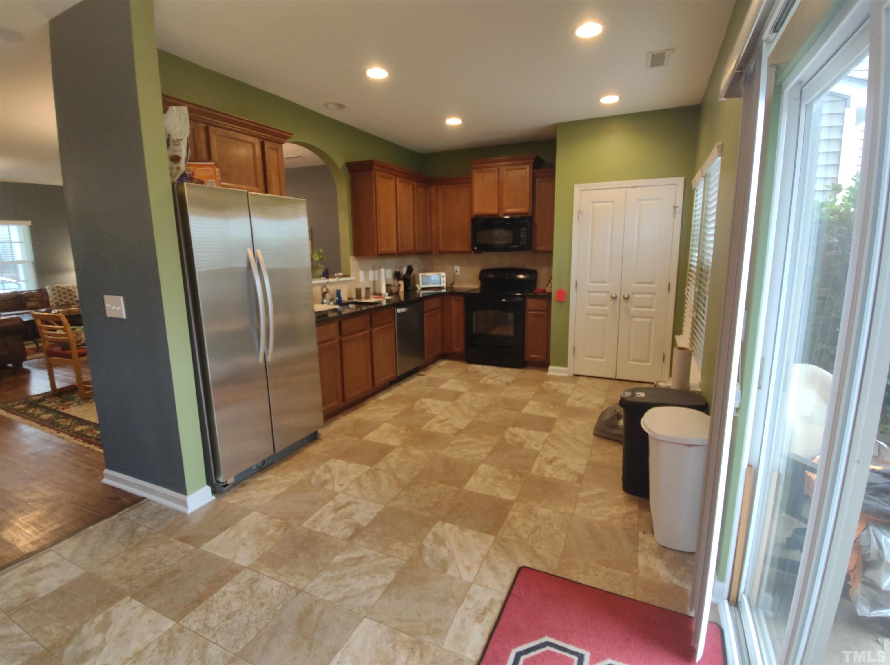 1125 Ileagnes Road Raleigh, NC 27603 - Photo 14 of 27 a large freezer with stainless steel appliances granite countertop a refrigerator and a sink