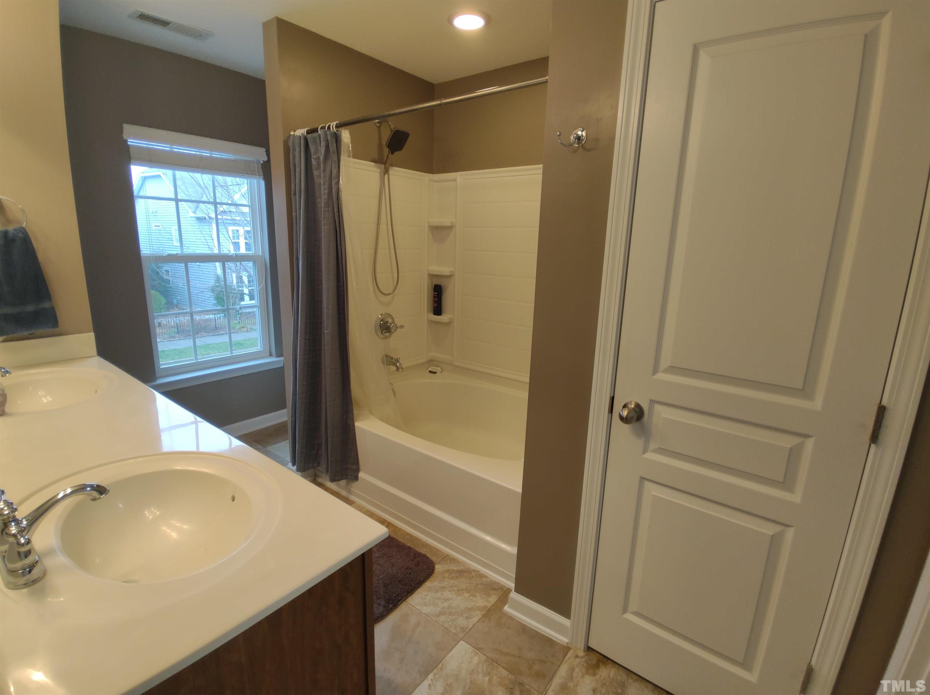 1125 Ileagnes Road Raleigh, NC 27603 - Photo 19 of 27 a bathroom with a sink and a tub