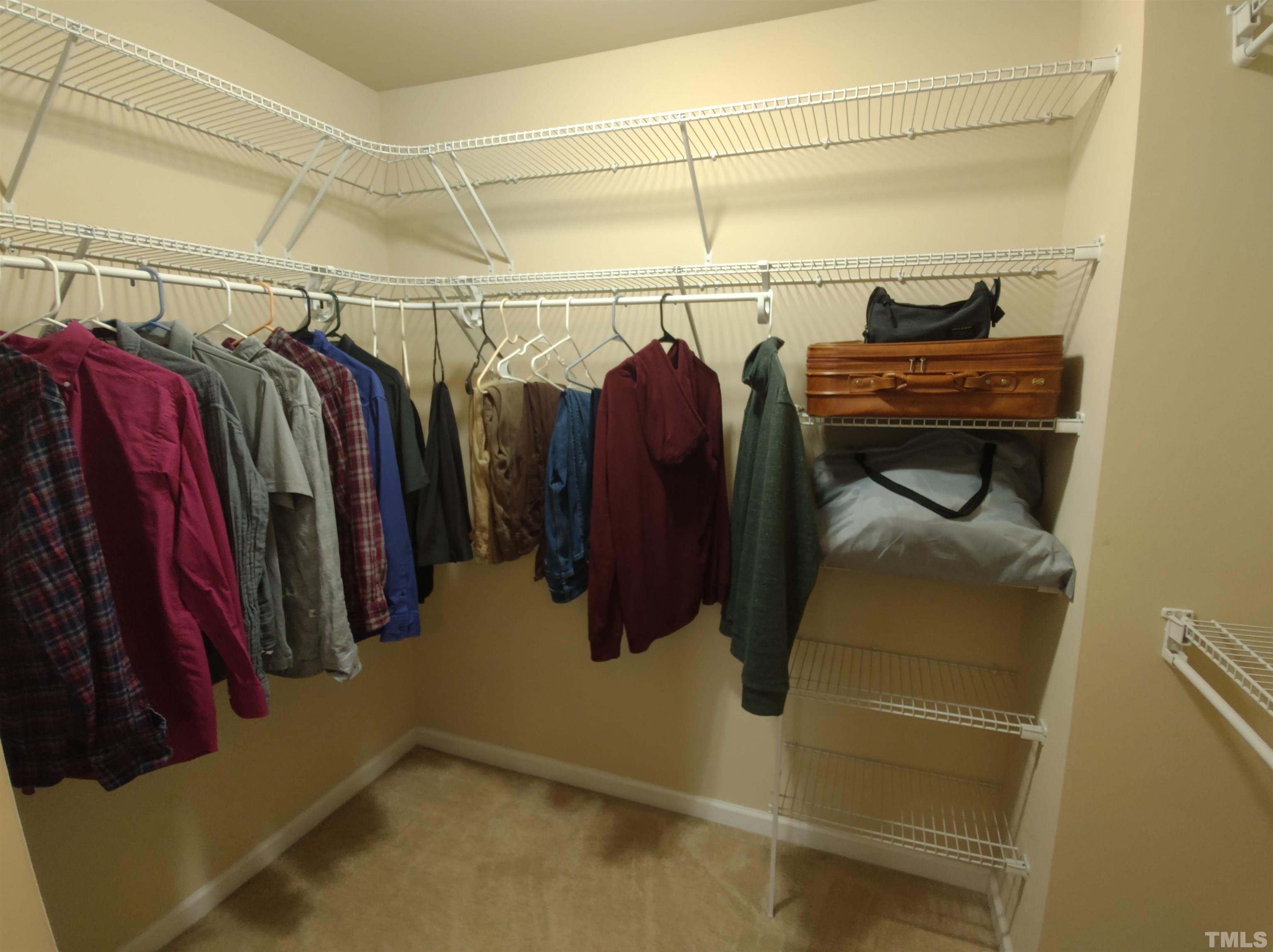 1125 Ileagnes Road Raleigh, NC 27603 - Photo 20 of 27 a view of walk in closet with clothes and shoes