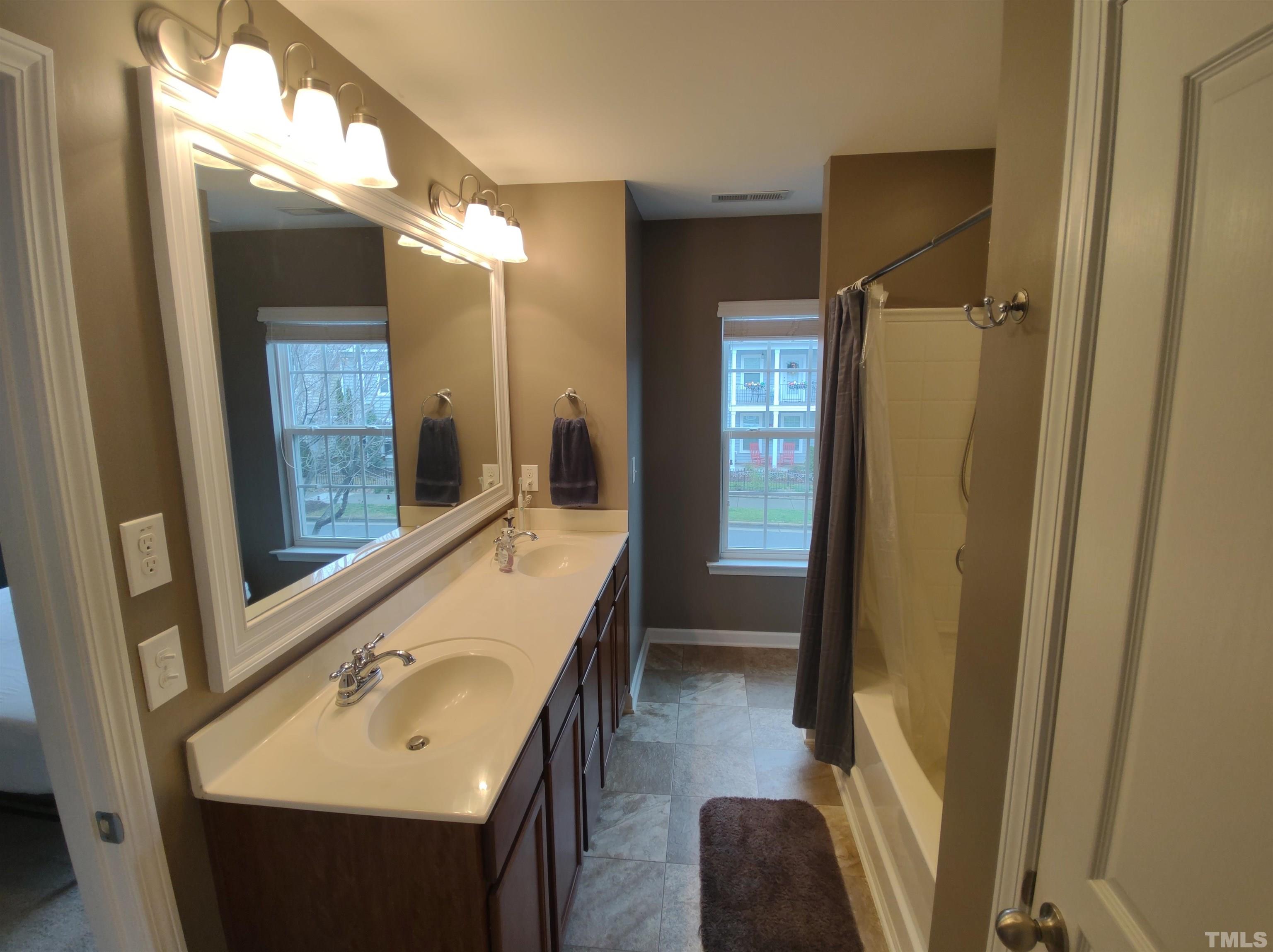 1125 Ileagnes Road Raleigh, NC 27603 - Photo 21 of 27 a bathroom with a sink and a mirror