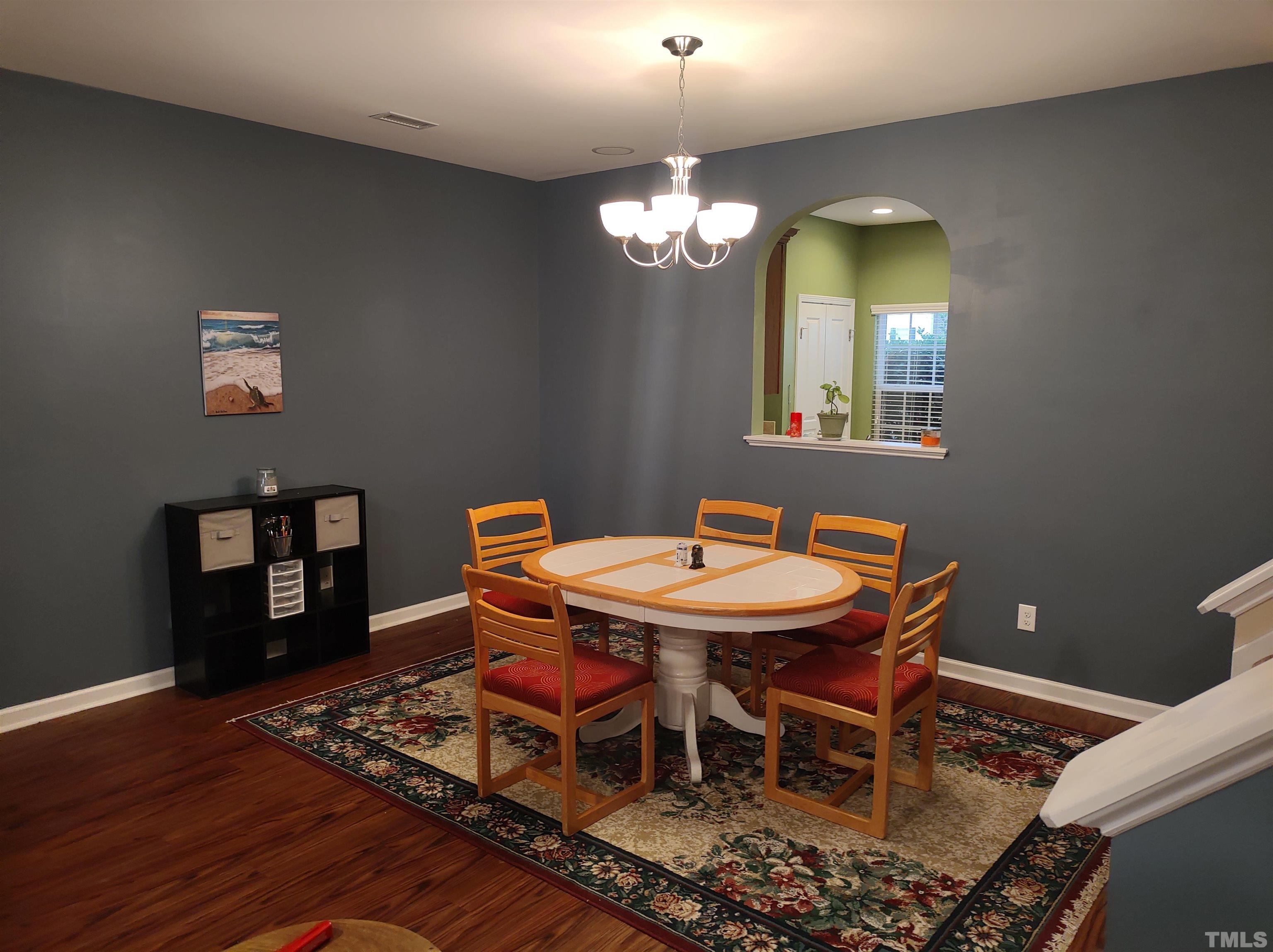 1125 Ileagnes Road Raleigh, NC 27603 - Photo 24 of 27 a view of a dining room with furniture and chandelier
