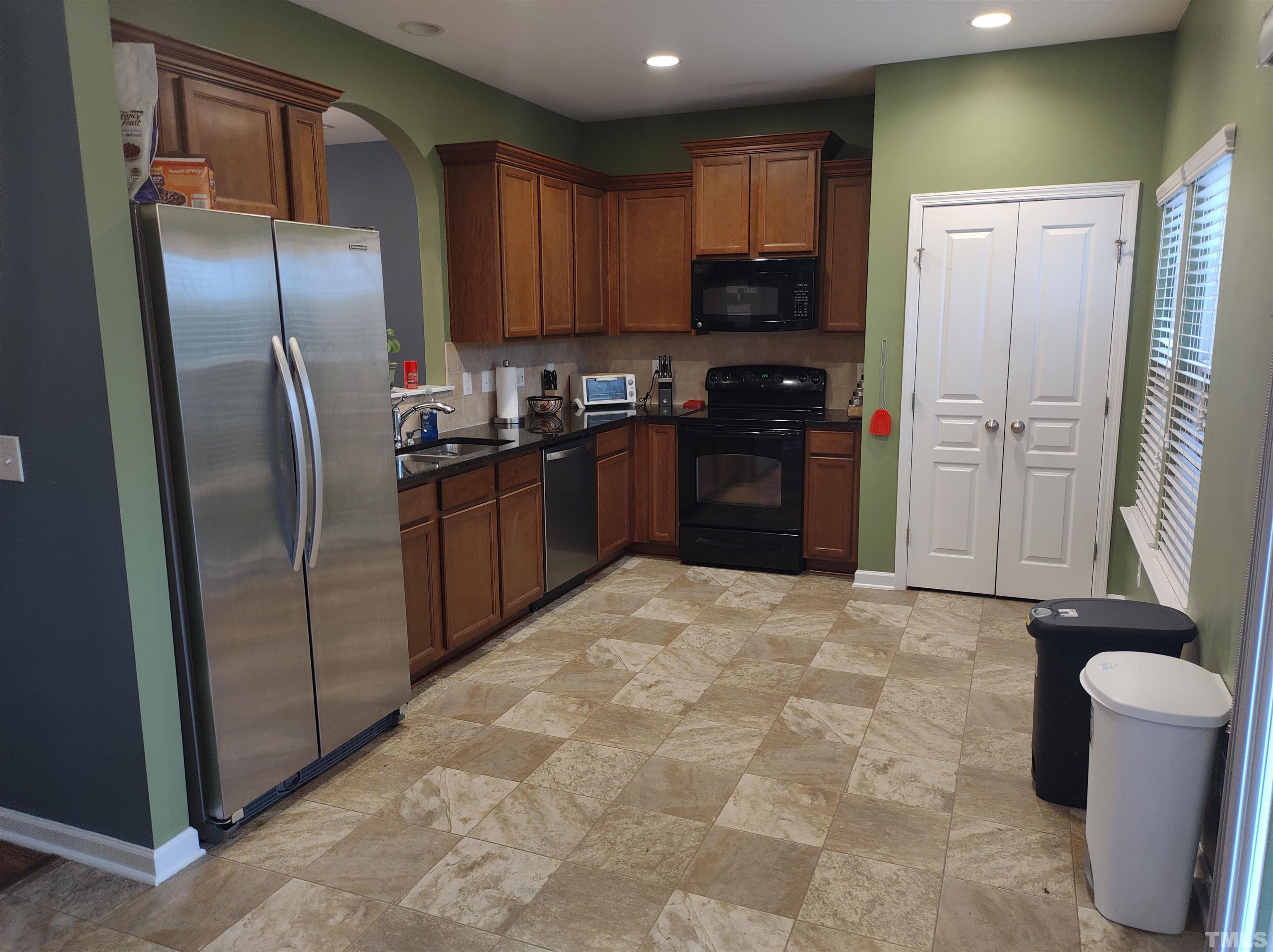 1125 Ileagnes Road Raleigh, NC 27603 - Photo 26 of 27 a kitchen with stainless steel appliances granite countertop a refrigerator stove and sink