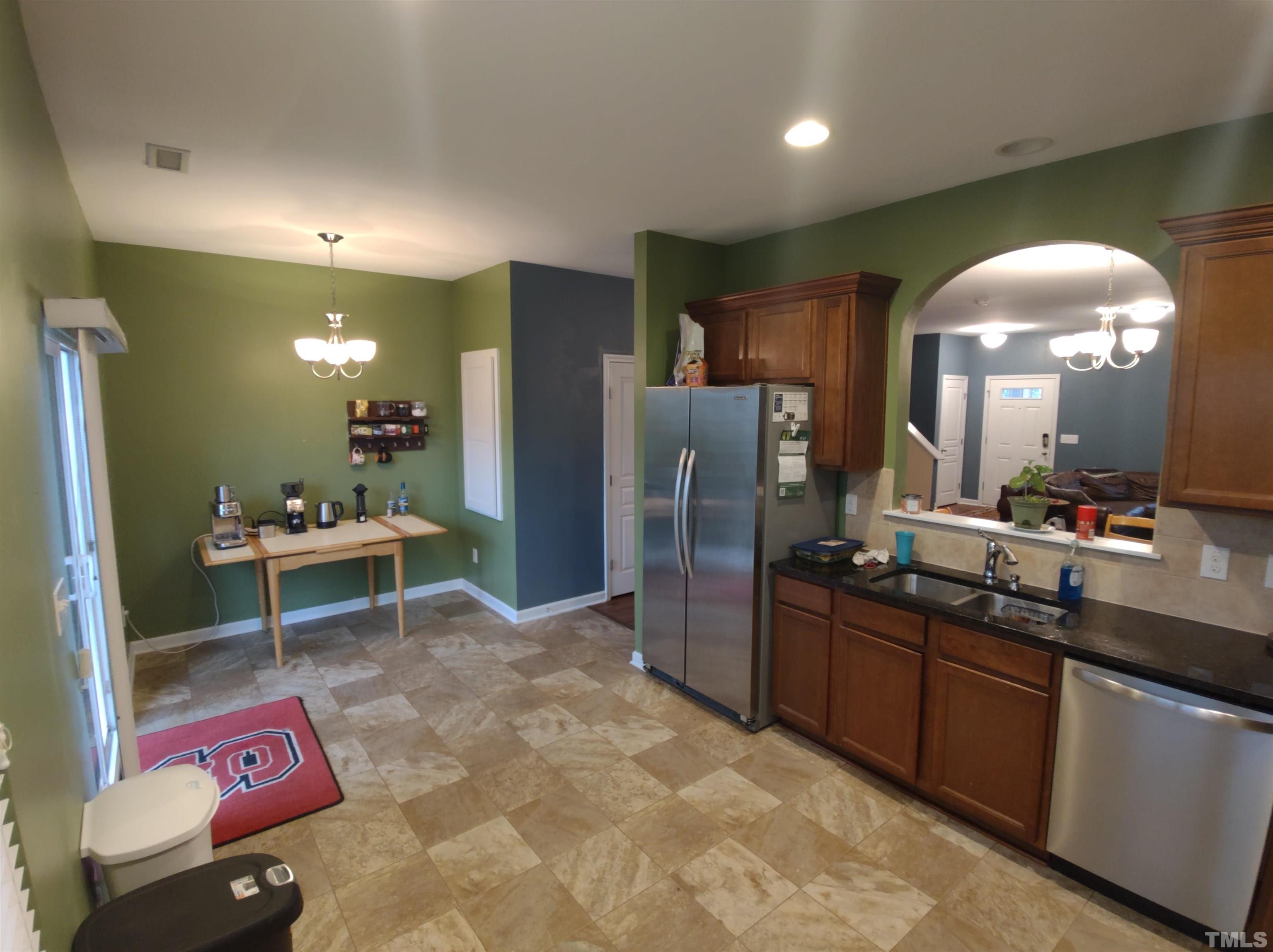 1125 Ileagnes Road Raleigh, NC 27603 - Photo 27 of 27 a kitchen with granite countertop a sink cabinets and stainless steel appliances