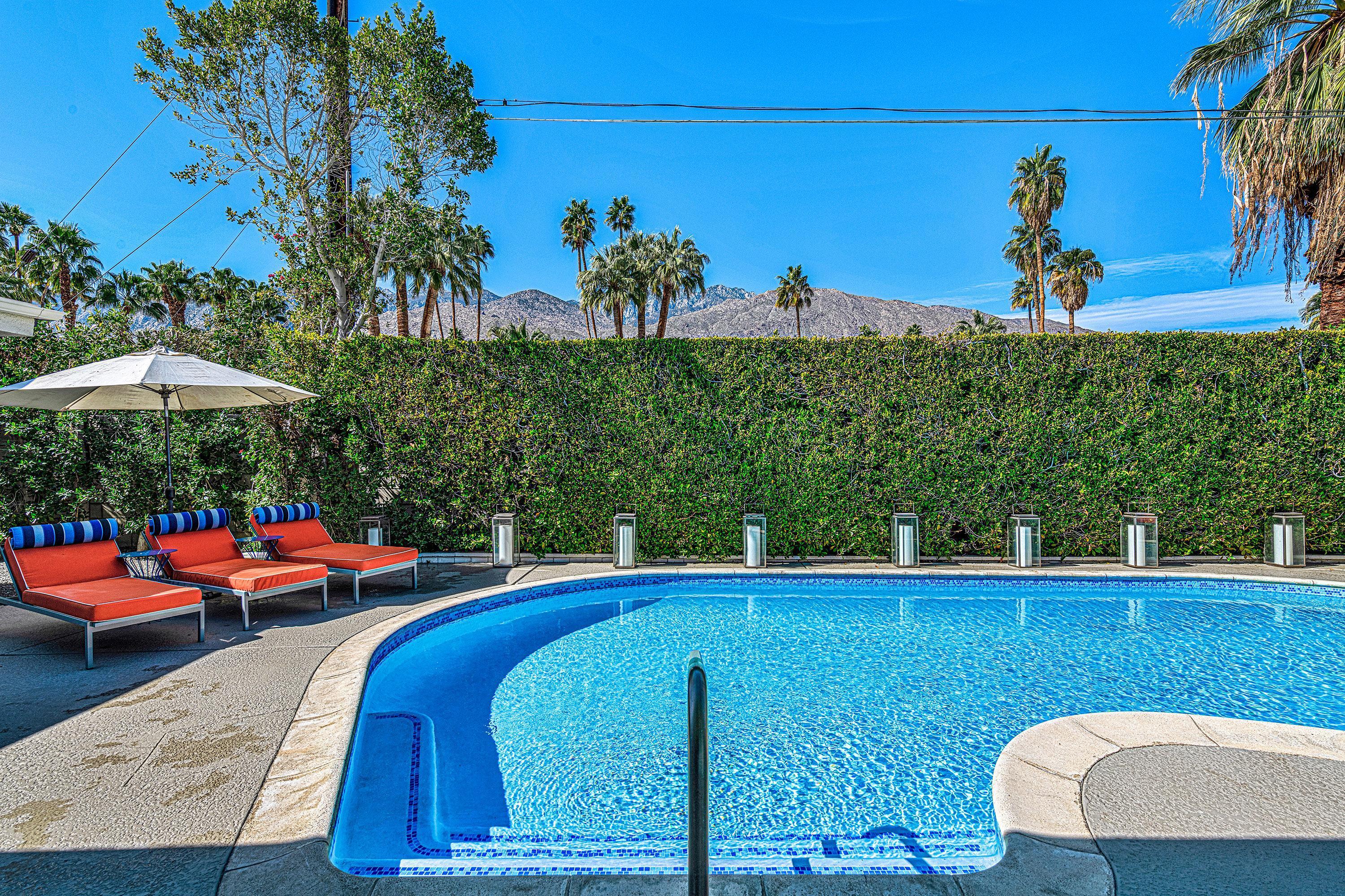 1130 East Deepwell Road Palm Springs, CA 92264 - Photo 17 of 55 a view of a swimming pool with a lounge chairs
