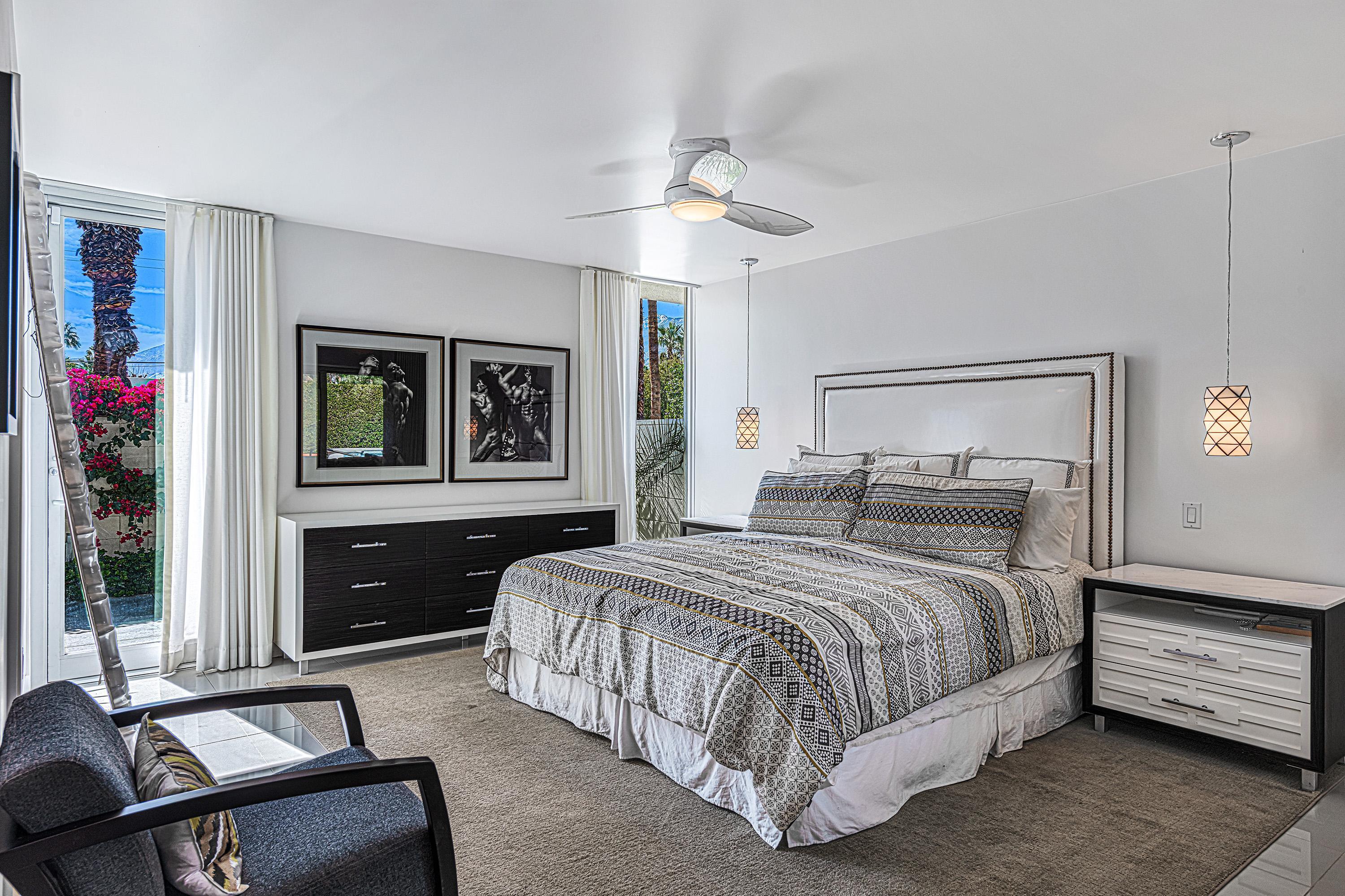 1130 East Deepwell Road Palm Springs, CA 92264 - Photo 23 of 55 a bedroom with a bed and a dresser