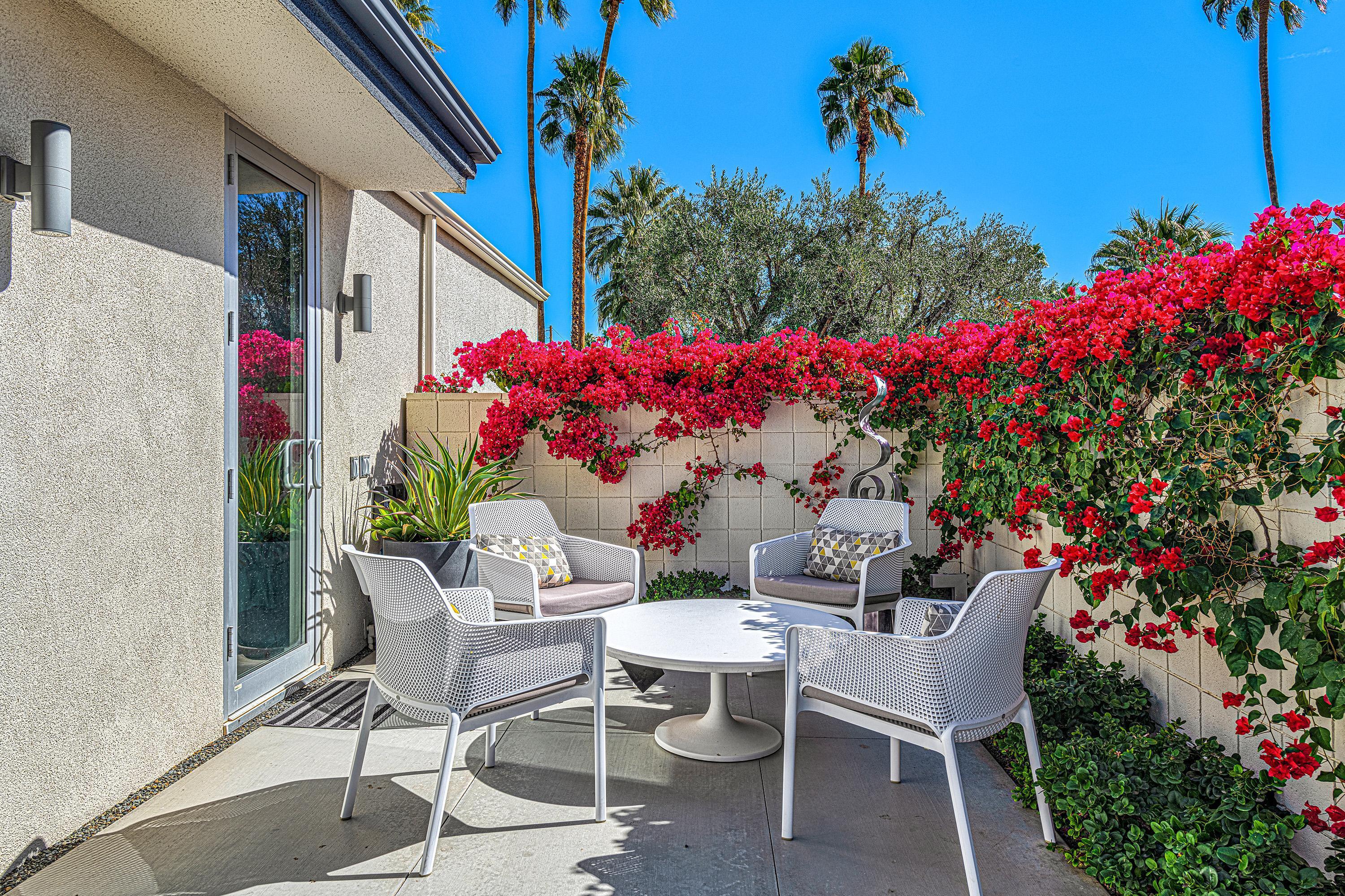 1130 East Deepwell Road Palm Springs, CA 92264 - Photo 26 of 55 a view of a chairs and table in a backyard