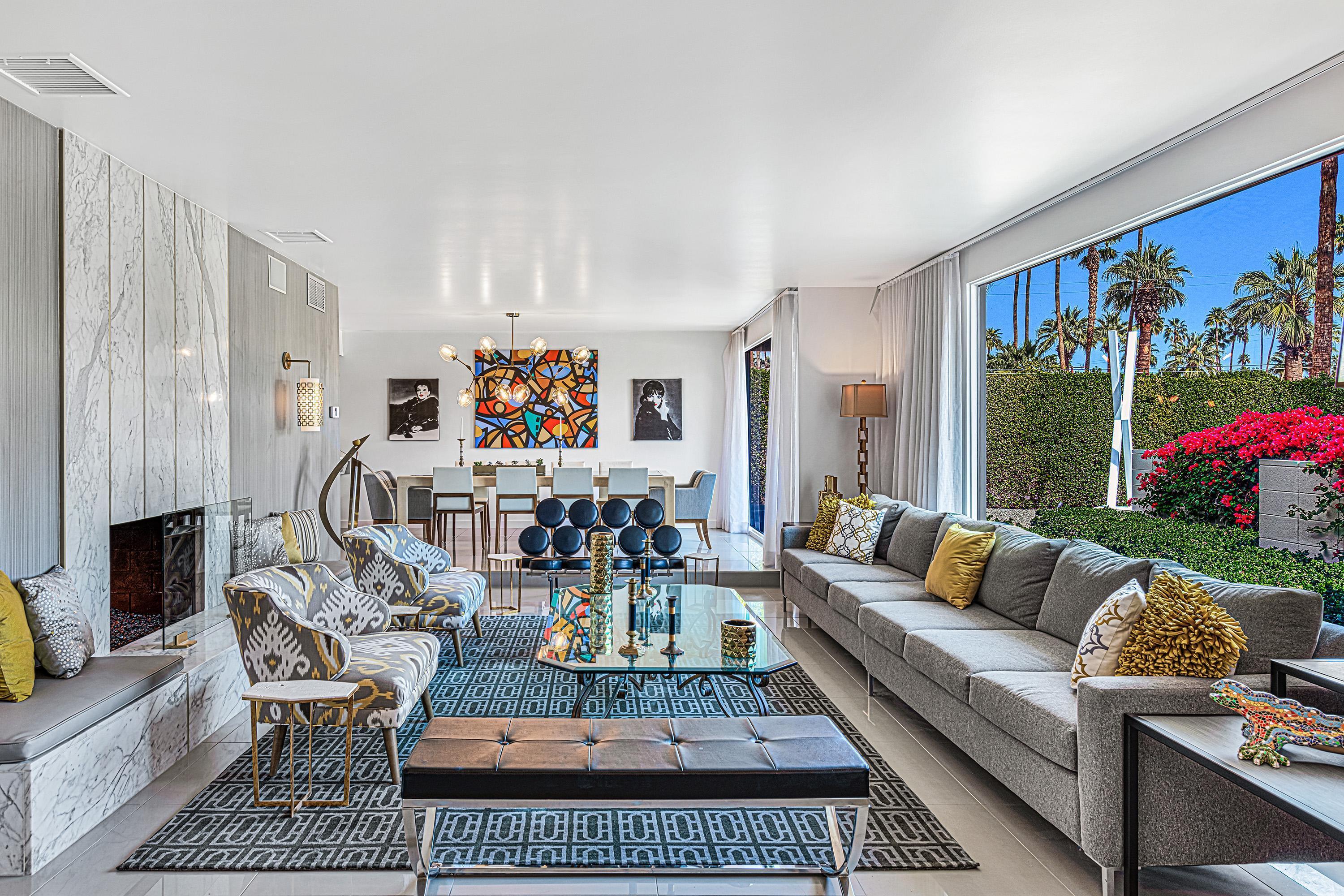 1130 East Deepwell Road Palm Springs, CA 92264 - Photo 4 of 55 a living room with furniture a fireplace and a large window
