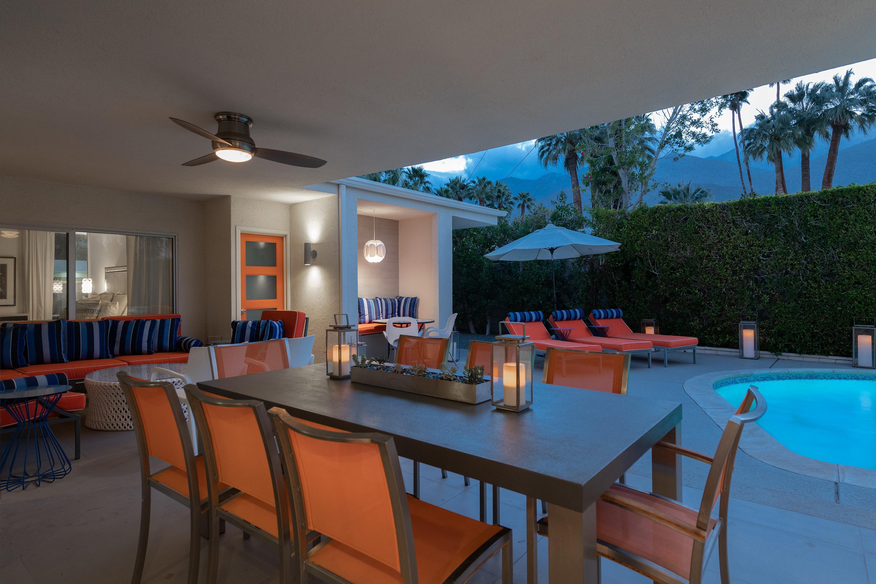 1130 East Deepwell Road Palm Springs, CA 92264 - Photo 44 of 55 a view of a dining room with furniture a chandelier and wooden floor