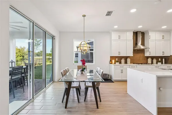 a kitchen with stainless steel appliances granite countertop a refrigerator and a stove top oven