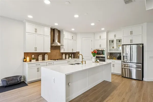 a kitchen with granite countertop a sink a stove and cabinets
