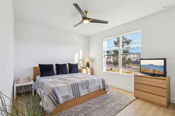 a bedroom with a bed and a flat screen tv
