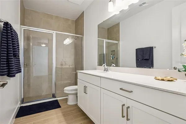 a bathroom with a toilet a sink and a mirror