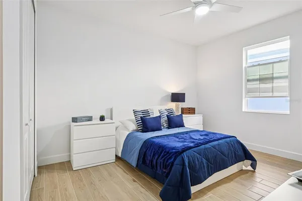 a bedroom with a bed and a potted plant