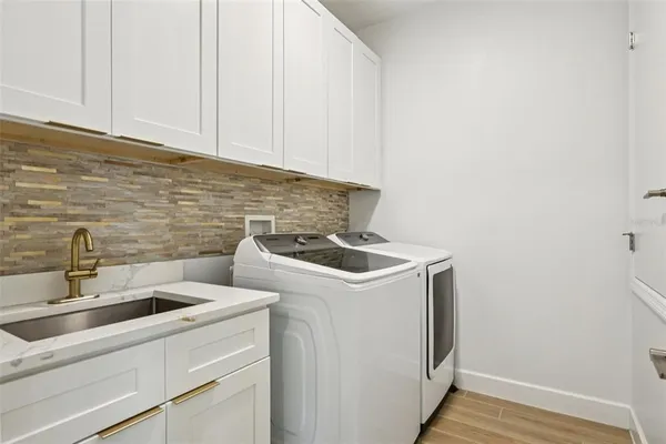 a bathroom with a sink vanity mirror and toilet