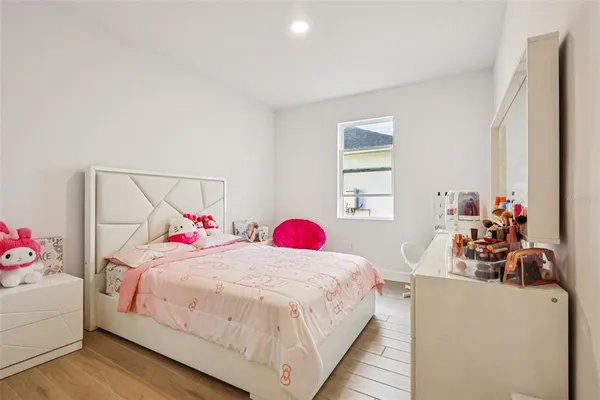 a bedroom with a large bed and a chandelier