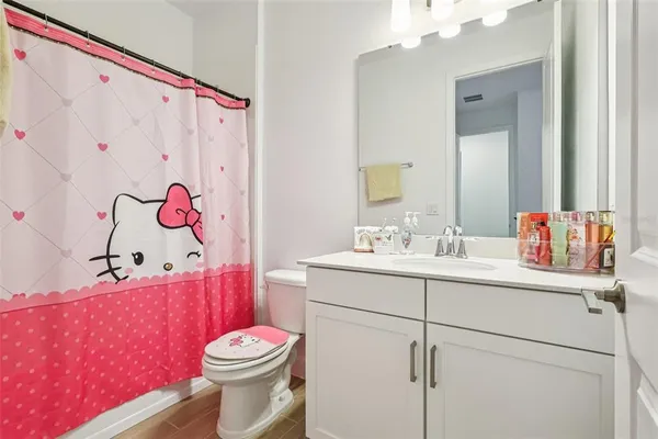 a bathroom with a shower sink and mirror