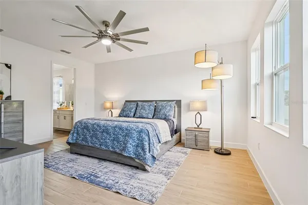 a room with kitchen island white cabinets and stainless steel appliances