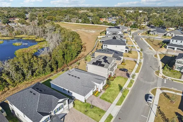 an aerial view of residential houses with outdoor space and parking