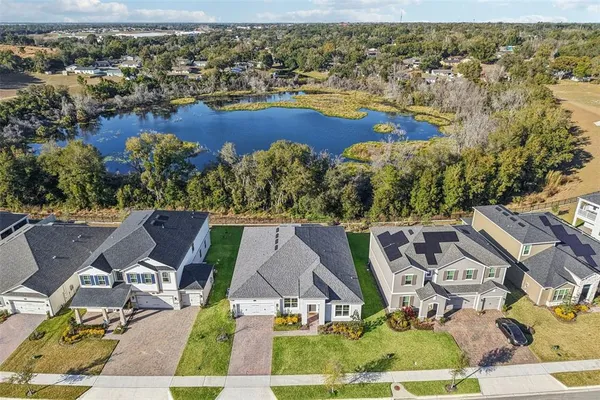 an aerial view of a house with a yard